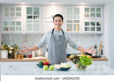 Asian Handsome Man Cooking At Home Preparing Salad In Kitchen. Healthy Eating, Vegetarian Food, Diet And People Concept