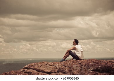 Asian handsome man sit alone on the mountain vintage style - Shutterstock ID 659908840