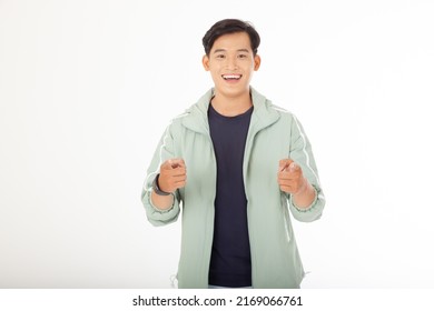 Asian Handsome Young And Cheerful Man In Fashionable Outfit And Point Finger To Copy Space, Isolated On White Background