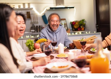 Asian Happy Big Family Enjoy Spend Time Together Celebrate Christmas Party, Eat Foods And Drink On Dinner Table At Home. Loving Grandparents Feel Happy To Meet Relative During Holiday Event In House.