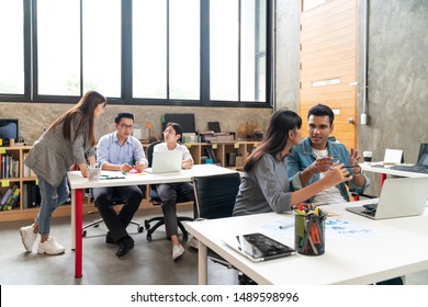 Asian Happy Business Creative Team In Routine Work Creative Lifestyle Sitting And Talking Together At Modern Office. Young Busy Diverse Teamwork Or Employee Brastorming Concept.