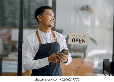 Asian Happy businessman and business owner standing in cafe. - Powered by Shutterstock