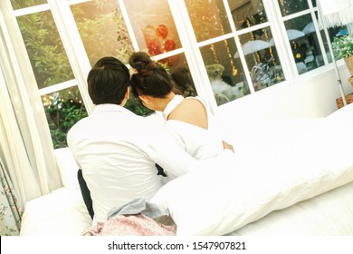Asian happy couple relaxing in white bed. Lifestyle real photo. - Shutterstock ID 1547907821