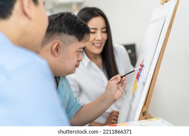 Asian Happy Family Draw Picture With Young Son In Living Room At Home. Beautiful Loving Mother And Father Take Care And Teach Young Man Patient To Painting Artwork Indoors At House. Lifestyle Activity