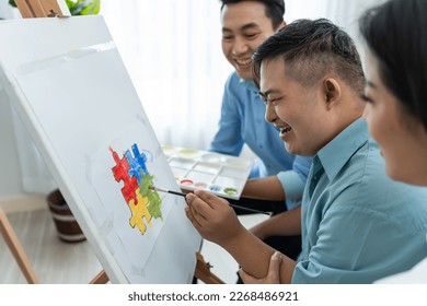 Asian happy family draw picture and young son in living room at home  Beautiful loving mother   father take care   teach young man patient to painting artwork indoors at house  Lifestyle activity