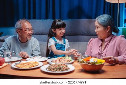 Asian Happy Family Having Lunch On Dinner Japanese Table Smiling Together. Little Kid Daughter Enjoy Eating Food Grandparents. Happiness Time People Lifestyle Concept.