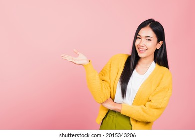 Asian Happy Portrait Beautiful Cute Young Woman Smile Standing Presenting Product Holding Something On Palm Away Side, Studio Shot Isolated On Pink Background With Copy Space, Female Show Hand Gesture