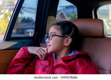 Asian Happy Student Smiling With Camera While Enjoying Road Trip In Car. Daughter Smiling And Looking Camera Inside Car In Morning. Asian Cildrens Sitting In Car On The Way Go To School. Family In Car