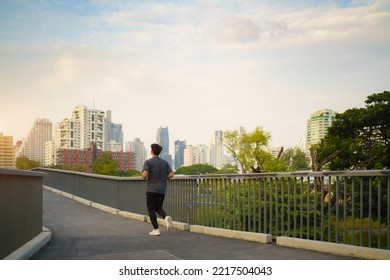 Asian healthy athlete man jogging at morning in public city park the city. - Powered by Shutterstock