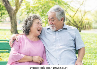 Asian healthy senior couple relaxing seated in the park together. - Powered by Shutterstock