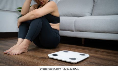 Asian Healthy Woman Bored Of Dieting Weight Loss Fail  Fat Diet And Scale Sad Asian Woman Upset On Weight Scale At Home Weight Control.