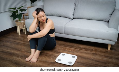 Asian Healthy Woman Bored Of Dieting Weight Loss Fail  Fat Diet And Scale Sad Asian Woman Upset On Weight Scale At Home Weight Control.