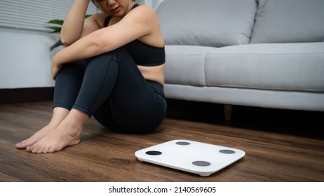 Asian Healthy Woman Bored Of Dieting Weight Loss Fail  Fat Diet And Scale Sad Asian Woman Upset On Weight Scale At Home Weight Control.