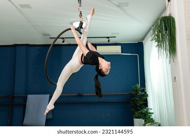 Asian healty sport female slim fit sportware yoga work out exercise Aerial Hoop indoor studio yoga  - Powered by Shutterstock