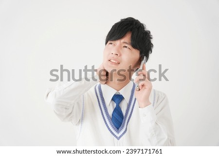 Asian high school boy with the smartphone having trouble in white background