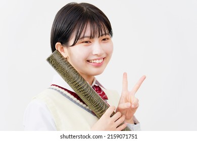 Asian high school student peace sign gesture with the diploma in a tube in white background