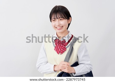 Asian high school student smiling in white background