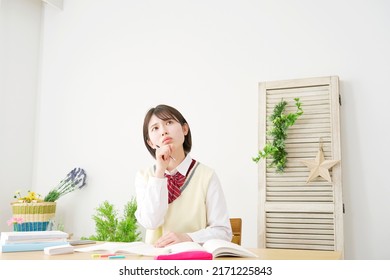 Asian High School Student Thinking While Studying At Home