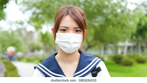 Asian High School Student Wear Face Mask And Look To You On Campus