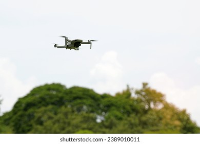 Asian high school students demonstrate flying drones or multirotor unmanned aerial vehicle technology. soft and selective focus.                                - Powered by Shutterstock