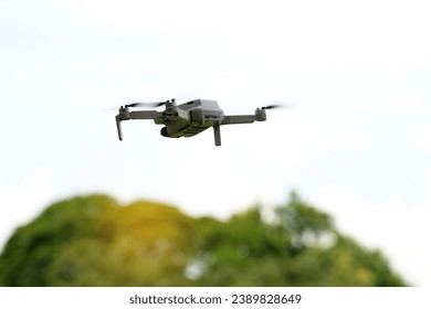 Asian high school students demonstrate flying drones or multirotor unmanned aerial vehicle technology. soft and selective focus.                                - Powered by Shutterstock