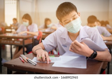 An Asian High School Students In A White School Uniform Wearing A Mask To Do Final Exams In The Midst Of Coronavirus Disease 2019 (COVID-19) Epidemic And PM 2.5.