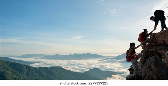 Asian hiking help each other on mountains view . teamwork concept - Powered by Shutterstock