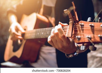 Asian Hipster Man Left Hand Catch Chord And Playing Music.