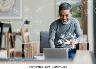 Asian Or Hispanic Man Using Laptop And Credit Card Payment Shopping Online With Icon Customer Network Connection On Screen And Connecting With Omni Channel System. Older Man Satisfied With CRM System