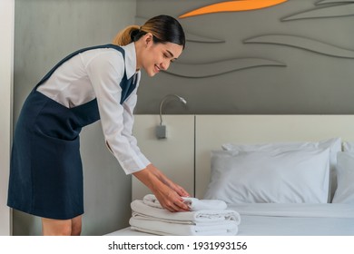 Asian Hotel Maid Arrange Fresh Towels Prepare For New Hotel Guest In Bedroom