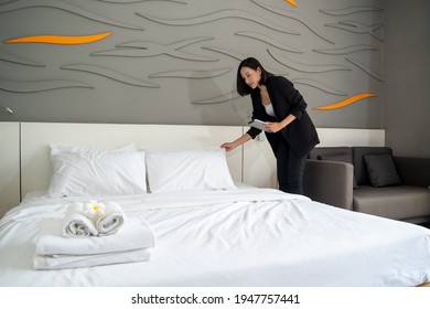 Asian Housekeeping Manager With Tablet Checking The Room Or Suite Of A Hotel.