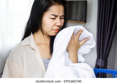 Asian Housewife Smelling Stinky Towel, Woman Having Problem With Bad Smell From Clothes 