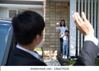 Asian Husband Waving Goodbye To His Wife And Child Before Going To Work