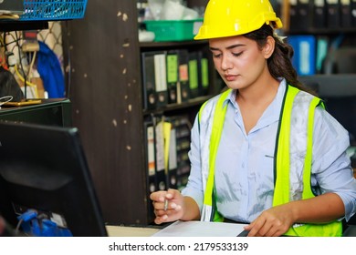 Asian Indian Beautiful Woman Warehouse Worker Checking Order  In Desktop Computer At Office Warehouse Factory. Check Emails.