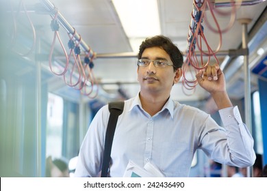 Asian Indian Business Man Taking Ride To Work, Standing Inside Train.