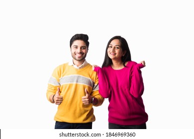 Asian Indian Couple Wears Colourful Warm Sweater Or Woolen Winter Cloths, Standing Isolated Against White Background