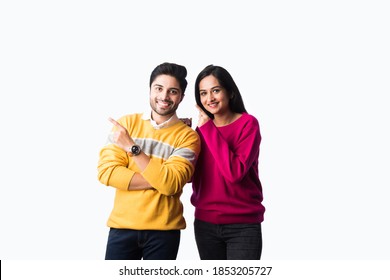 Asian Indian Couple Wears Colourful Warm Sweater Or Woolen Winter Cloths, Standing Isolated Against White Background