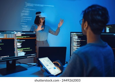 asian and Indian developer devops team testing  virtual reality coding and presentation  with ai prompt  at night in office
