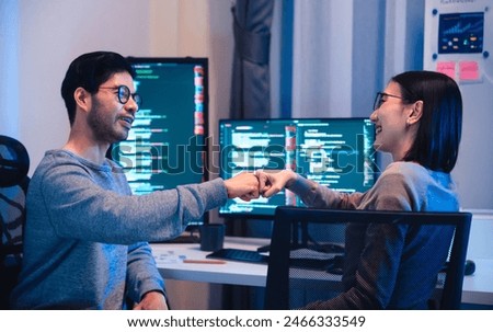 asian and Indian Developer team clapping hand for project success  with software computer at night in office
