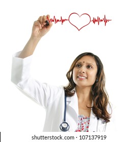 Asian Indian female doctor drawing a heartbeat over white background. Medical concept - Powered by Shutterstock