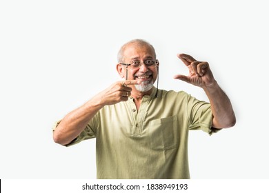 Asian Indian Senior Or Old Man Presenting Empty Space, Standing Isolated Against White Background