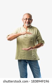 Asian Indian Senior Or Old Man Presenting Empty Space, Standing Isolated Against White Background