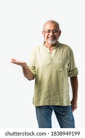 Asian Indian Senior Or Old Man Presenting Empty Space, Standing Isolated Against White Background