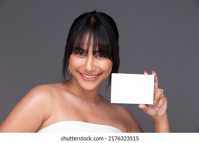 Asian Indian Woman Show Beautiful Smile Happy Lips, Hold Empty Blank Package Box For Treatment Skin Care. India Female Feel Wellbeing With Medicine Capsule In Studio Over Gray Background Isolated