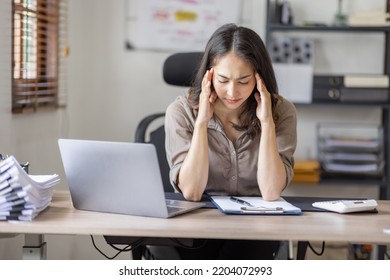 Asian indian women are stressed while working on laptop, Tired asian businesswoman with headache at office, feeling sick at work copy space in workplace an home office. - Shutterstock ID 2204072993