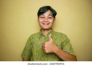 Asian Indonesian man wearing batik clothes on National Batik Day - Shutterstock ID 2369785951