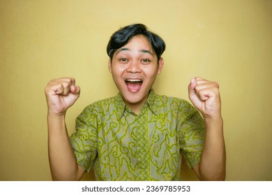 Asian Indonesian man wearing batik clothes on National Batik Day - Shutterstock ID 2369785953