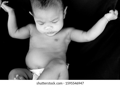 Asian infant baby girl lays on chair