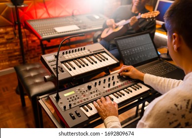 asian keyboardist jamming music with guitarist in sound studio. focus on hand - Powered by Shutterstock