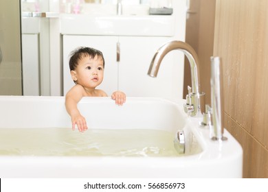 Asian Kid In The Bathroom With Bathtub